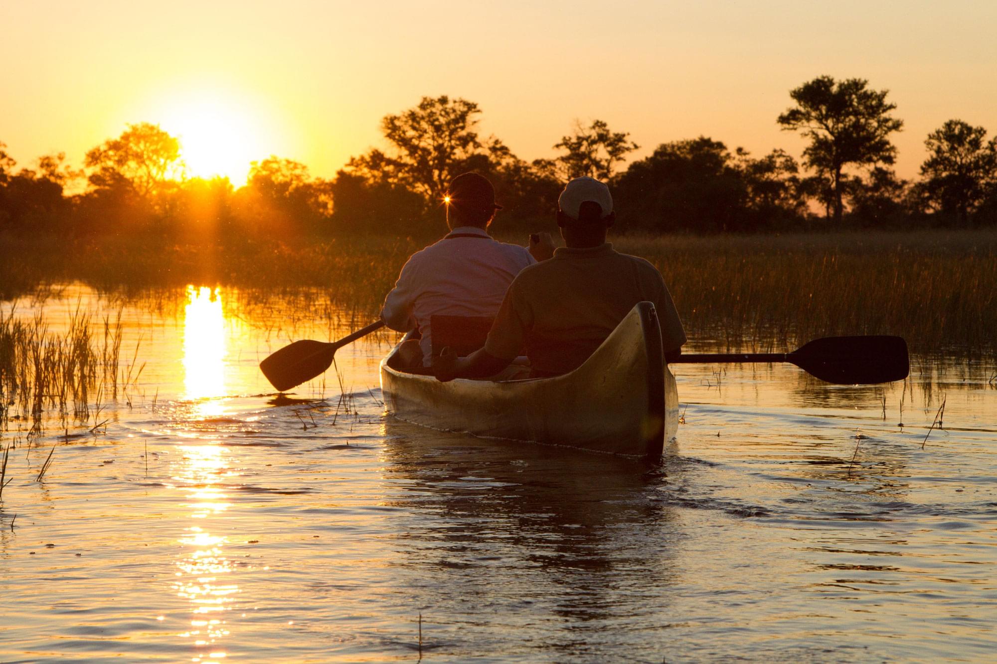Canoe gliding into the sunset